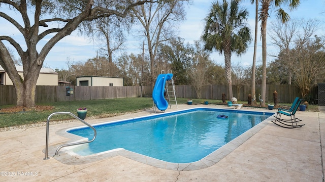 view of swimming pool featuring a water slide, a fenced backyard, a yard, a fenced in pool, and a patio area