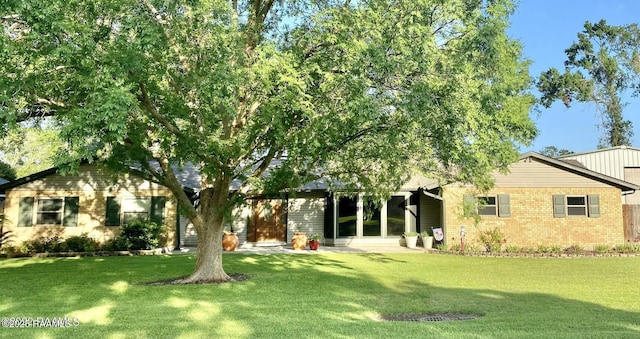 view of front of house featuring a front yard and brick siding