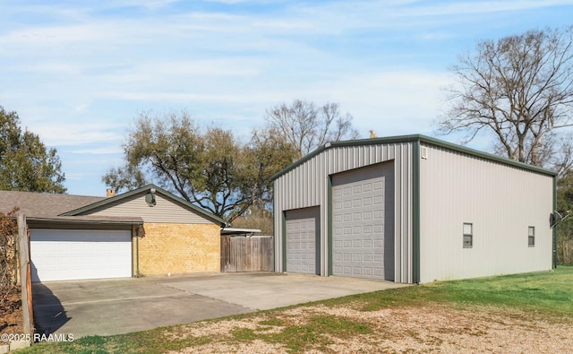 detached garage featuring fence