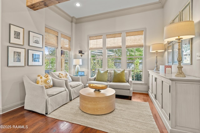 living area with baseboards, recessed lighting, wood finished floors, and crown molding