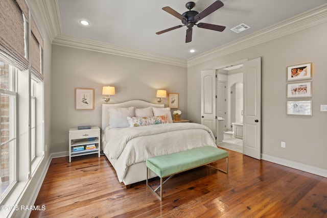 bedroom featuring arched walkways, wood-type flooring, and baseboards