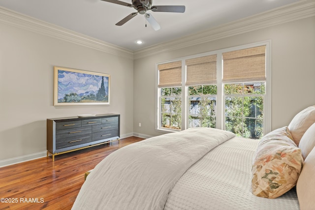 bedroom featuring ceiling fan, recessed lighting, dark wood-type flooring, baseboards, and crown molding