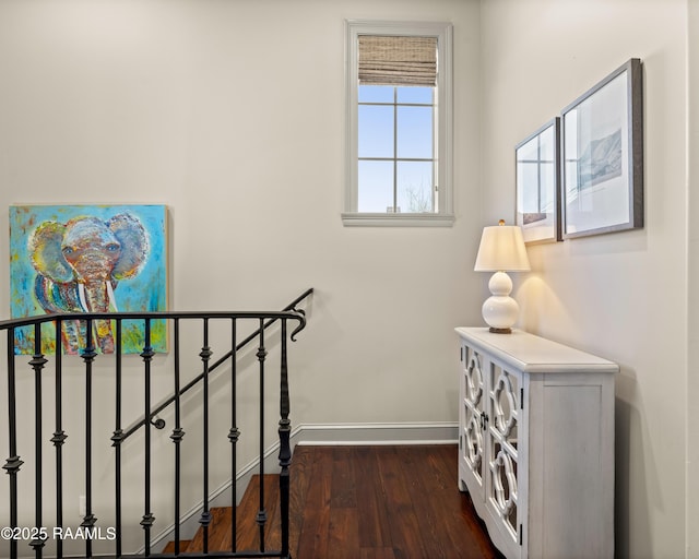 hall with dark wood finished floors and baseboards