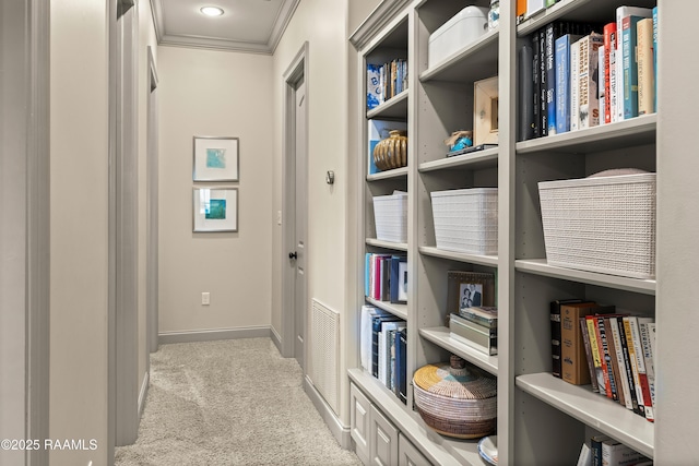 hallway with ornamental molding, carpet flooring, and baseboards