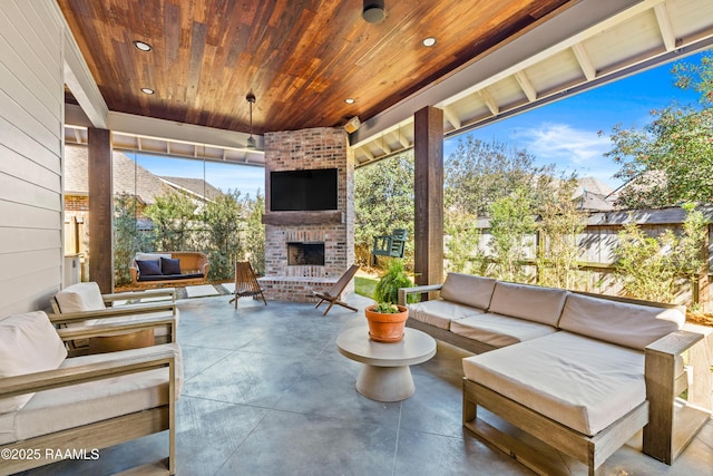 view of patio with an outdoor living space with a fireplace and fence