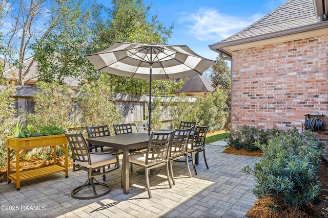 view of patio with fence and outdoor dining area