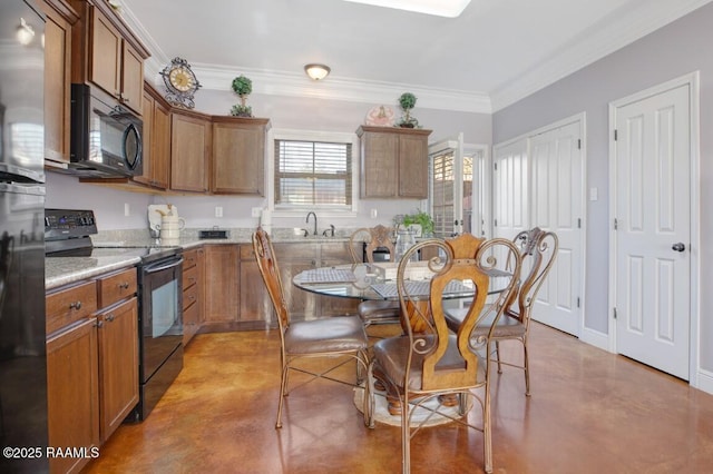 kitchen with black appliances, ornamental molding, brown cabinetry, and concrete flooring