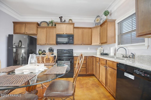 kitchen featuring black appliances, ornamental molding, light stone counters, and a sink