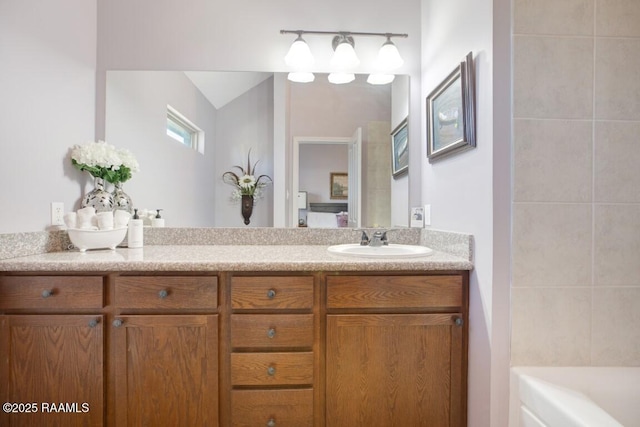 full bath with double vanity, a bathing tub, vaulted ceiling, and a sink