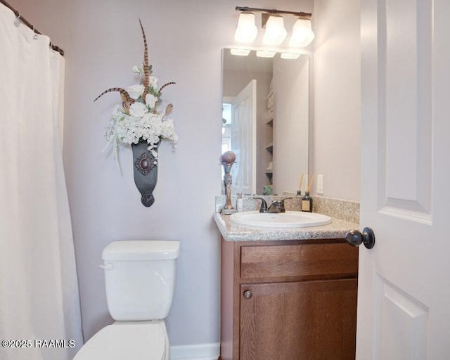 full bathroom with toilet and vanity