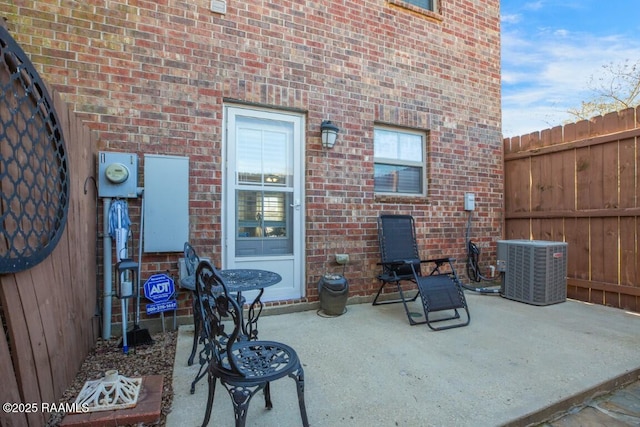 view of patio / terrace with central AC and fence