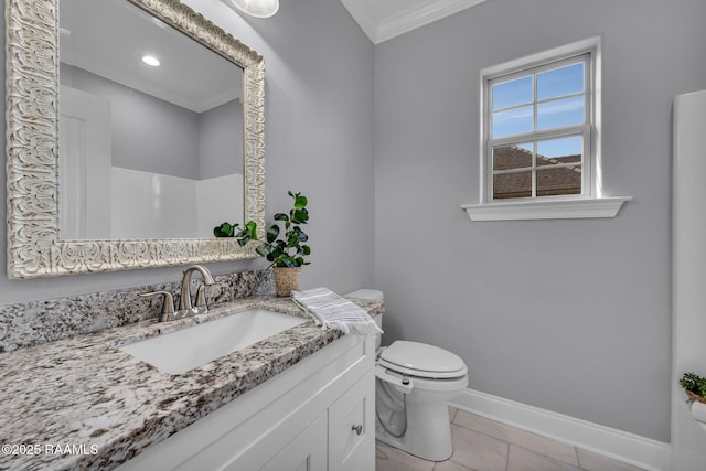 bathroom featuring tile patterned flooring, toilet, vanity, baseboards, and ornamental molding