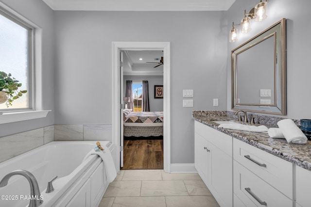 full bathroom with crown molding, a wealth of natural light, connected bathroom, and vanity