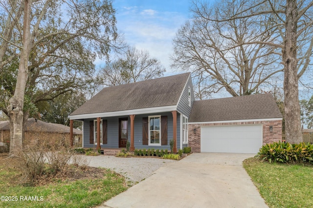 view of front of home featuring a garage, a porch, concrete driveway, and roof with shingles