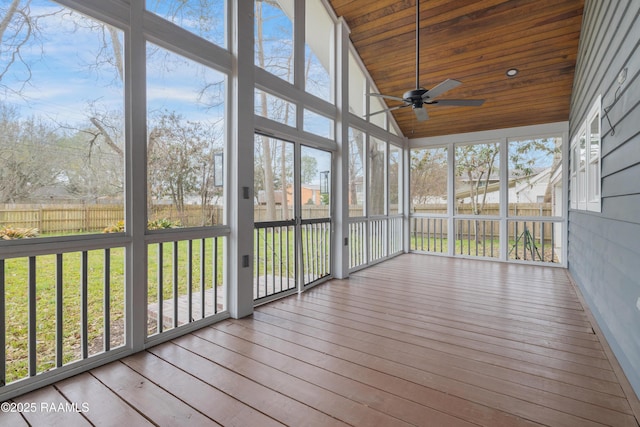 unfurnished sunroom with lofted ceiling, wood ceiling, and a healthy amount of sunlight