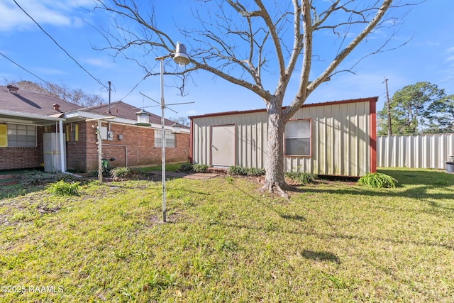 view of yard featuring an outbuilding and fence