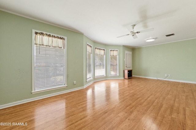 unfurnished living room with crown molding, light wood-style floors, and ceiling fan