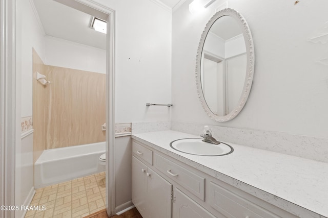 full bathroom with vanity, crown molding, toilet, and shower / tub combination