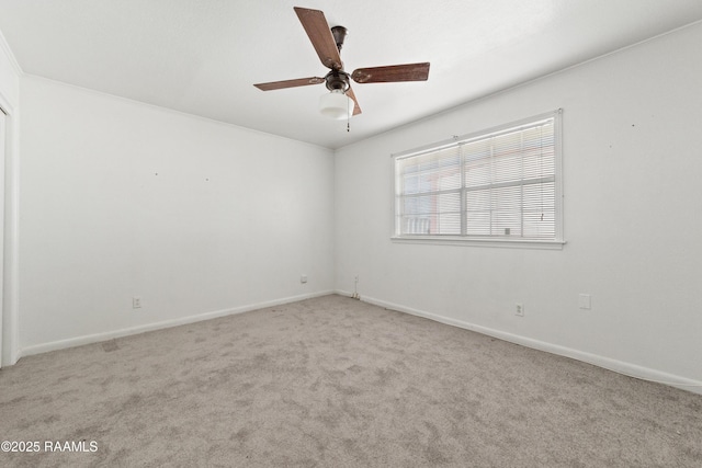 unfurnished room with baseboards, a ceiling fan, and carpet