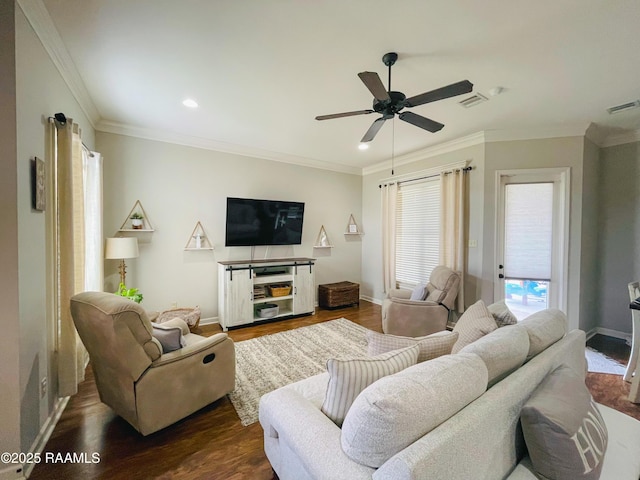 living area featuring dark wood-type flooring, visible vents, ornamental molding, and baseboards