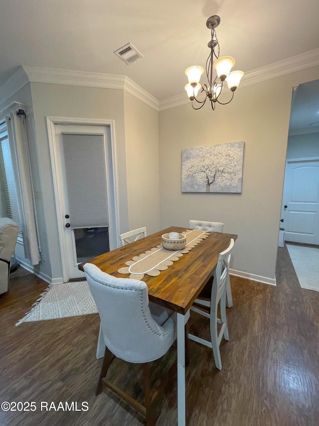 dining room featuring a chandelier, visible vents, baseboards, ornamental molding, and dark wood-style floors