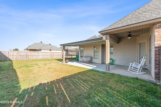 view of yard with a ceiling fan, a patio area, a trampoline, and fence