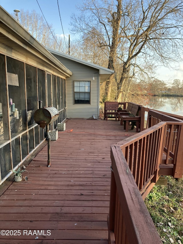 wooden deck with a water view and a sunroom