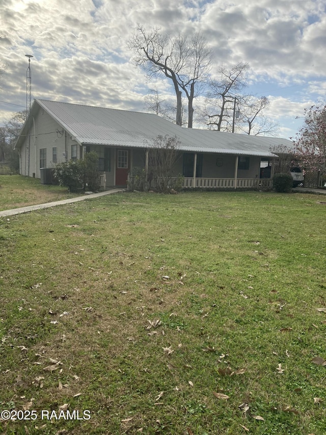 ranch-style house with a front yard and metal roof