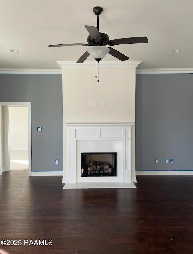 unfurnished living room featuring crown molding, a fireplace, baseboards, and wood finished floors