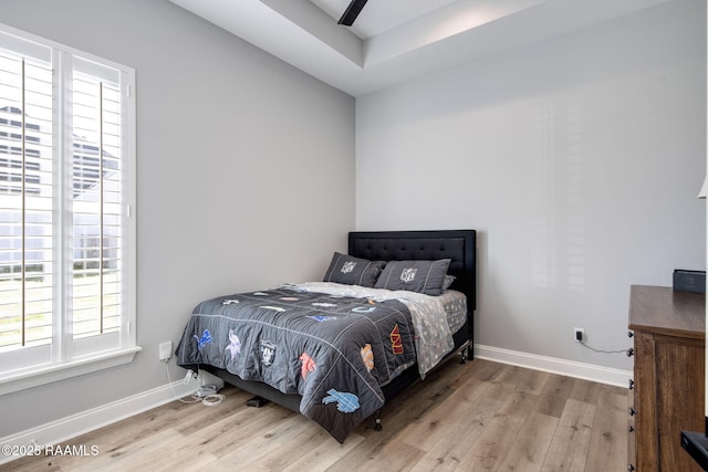 bedroom featuring baseboards and wood finished floors