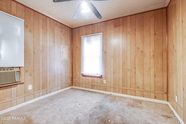 unfurnished room featuring wood walls, cooling unit, a ceiling fan, and crown molding