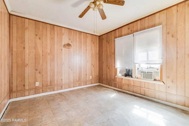 spare room featuring crown molding, wood walls, ceiling fan, and tile patterned floors