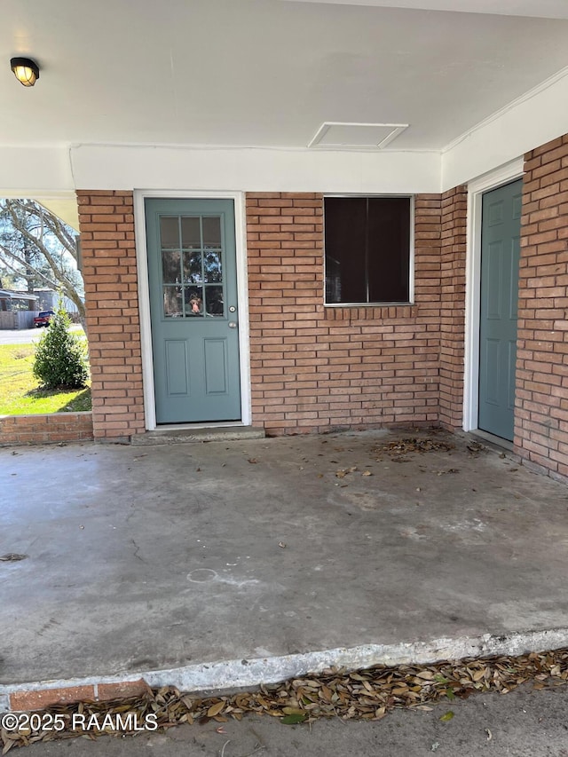 entrance to property with brick siding