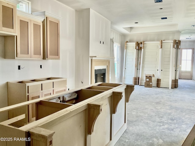 kitchen featuring concrete floors and a fireplace