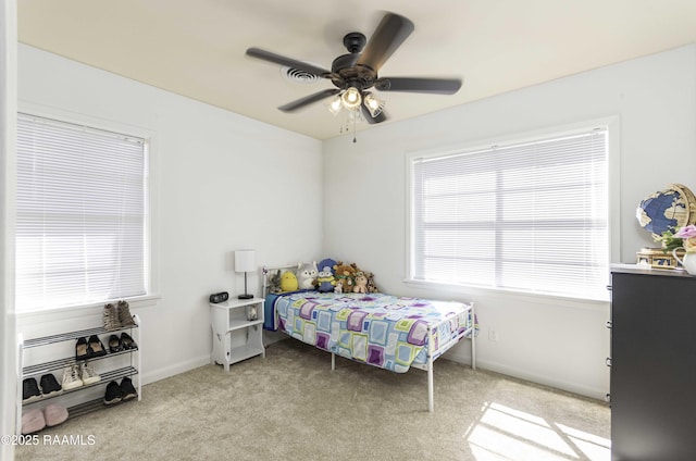 carpeted bedroom featuring ceiling fan and baseboards