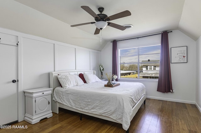 bedroom with vaulted ceiling, ceiling fan, wood finished floors, and baseboards