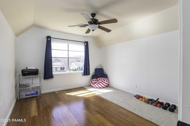 interior space featuring vaulted ceiling, ceiling fan, wood finished floors, and baseboards