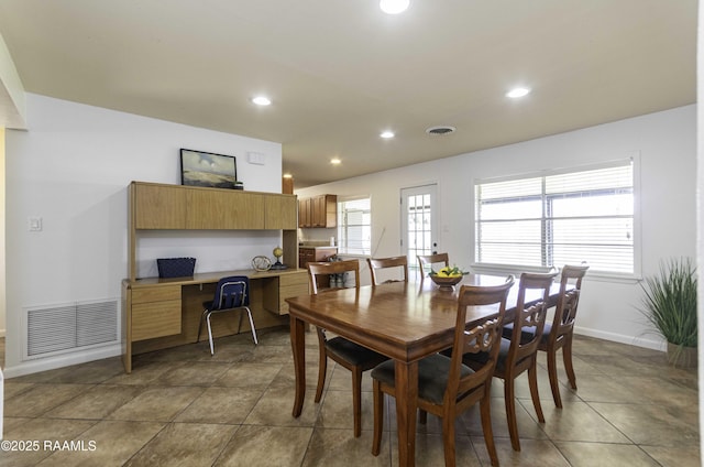 dining space with recessed lighting, visible vents, and built in study area