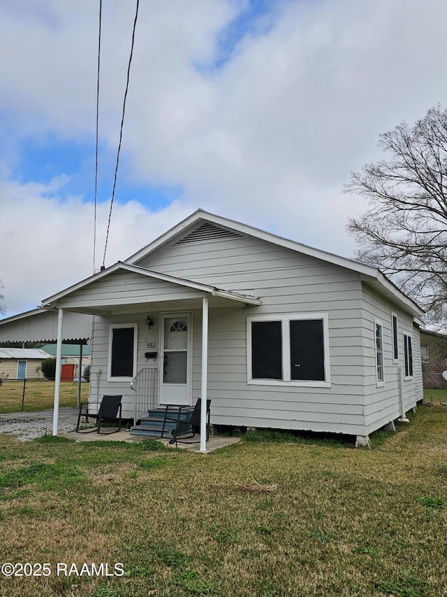 back of house with a yard and fence