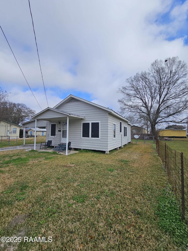 view of front of home with fence private yard and a front lawn