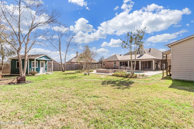 view of yard featuring an outbuilding, a patio, a fenced backyard, and a fenced in pool