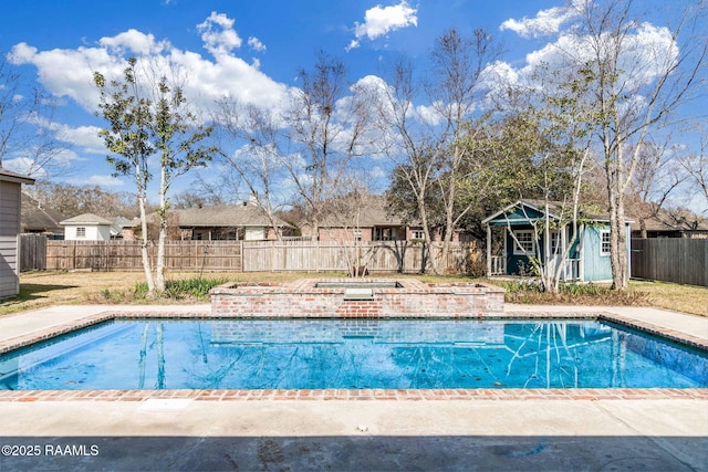 view of pool with a fenced backyard, a fenced in pool, and an outdoor structure