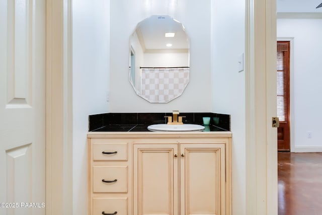 full bath with vanity and baseboards