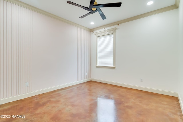 spare room featuring ornamental molding, concrete floors, and baseboards