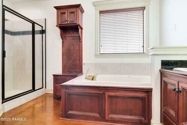 full bathroom with a stall shower, a bath, and vanity