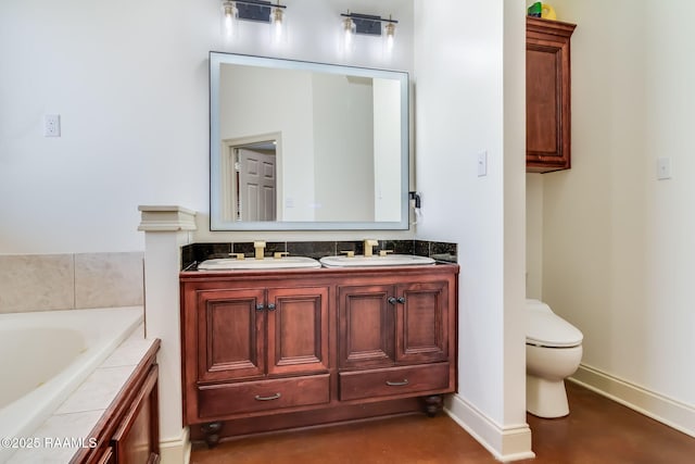 full bath with toilet, a garden tub, double vanity, and a sink