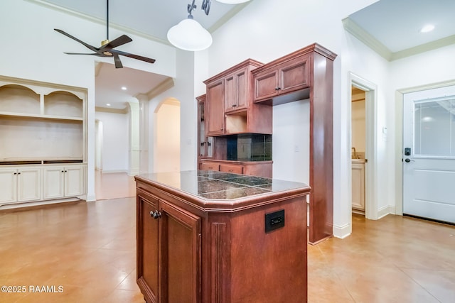 kitchen with arched walkways, a ceiling fan, backsplash, and crown molding