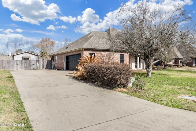 view of property exterior with a garage, brick siding, a yard, concrete driveway, and roof with shingles