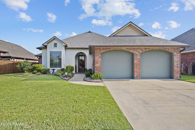 view of front of home featuring a shingled roof, a front yard, concrete driveway, and fence