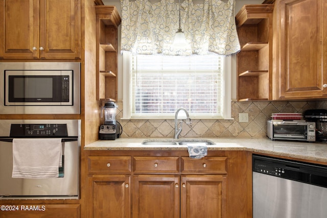 kitchen with open shelves, brown cabinets, stainless steel appliances, and a sink